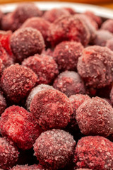 Frozen cherry fruit close up. Cherry in ice crystals.