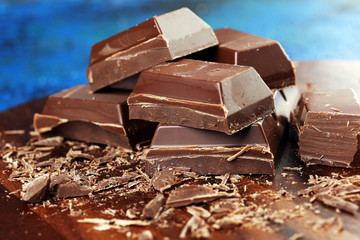 Dark chocolate stack, chips and powder with chocolate bars and block