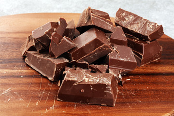Dark chocolate stack, chips and powder with chocolate bars and block