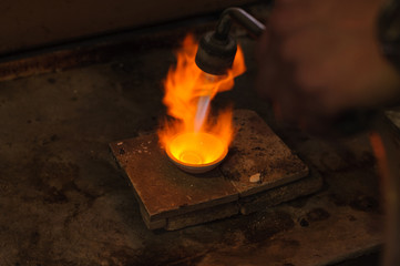 Jeweler melts metal for jewelry