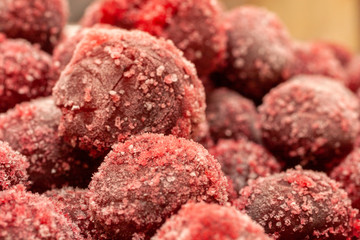 Frozen cherry fruit close up. Cherry in ice crystals.