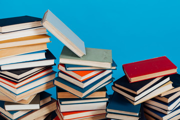a lot of stacks of educational books in the college library on a blue background