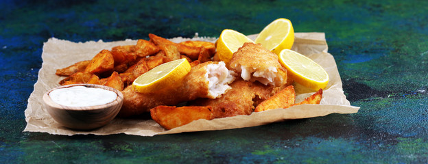 traditional British fish and chips consisting of fried fish, potato chips and mayonnaise