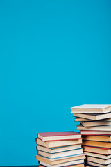 a lot of stacks of educational books in the college library on a blue background