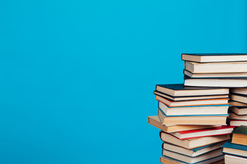 a lot of stacks of educational books in the college library on a blue background