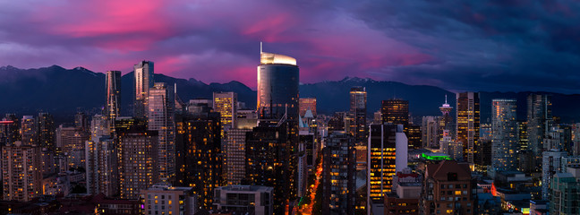 Aerial Panorama of the beautiful modern downtown city during the night after sunset. Vancouver, British Columbia, Canada. Colorful Clouds Composite