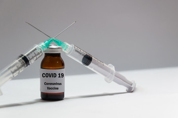 Bottle with coronavirus cure. Vaccine and syringe injection on white background.