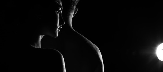 silhouette of a couple. Shadow couple. Man and woman studio. Background. Dark. Sensual. 