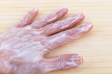 A large amount of cream on the outside of the palm.Close up.Selective focus.Concept of care,moisturizing, nutrition, masks for the skin of the hands.