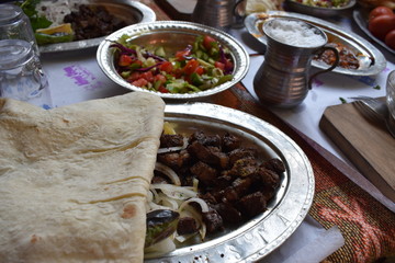 Kebab restaurant table with liver kebab salad and ayran on the table