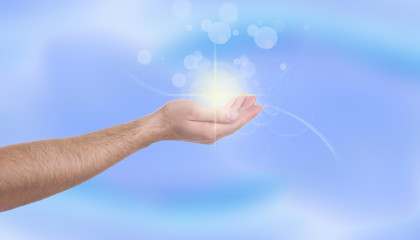 Man holding concentrated healing energy in his hand, closeup