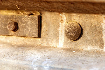 rivet in a metal profile close-up. Installed large metal rivet. Metal construction close up