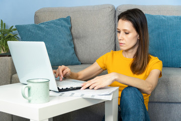 Beautiful serious young woman working from home. Stay at home concept.