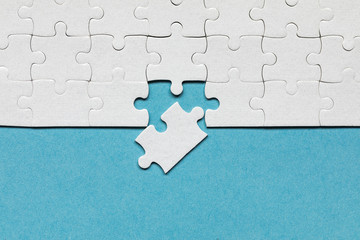 White jigsaw puzzle pieces. Fill in pieces of the jigsaw puzzle. Complete the jigsaw puzzle with...