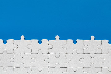 White jigsaw puzzle pieces. Fill in pieces of the jigsaw puzzle. Complete the jigsaw puzzle with...