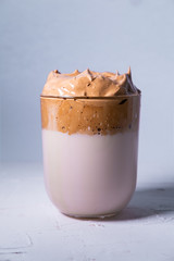 Dalgona coffee isolated on white background. Korean iced coffee. Close up view. Vertical picture.