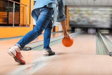 Man playing bowling in club