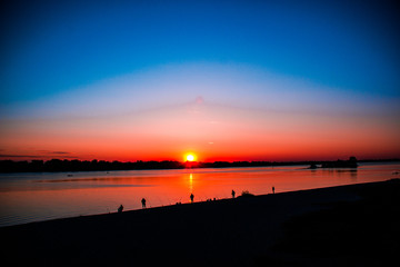 Fototapeta na wymiar Beautiful sunset over the river and fishermen