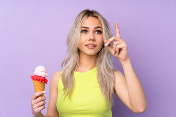 Teenager girl over isolated purple background intending to realizes the solution while lifting a finger up