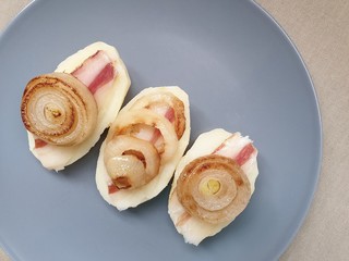 Boiled potatoes with bacon and fried onions 