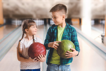 Fototapeta premium Little children playing bowling in club