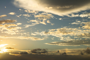 Beautiful clouds scattered across the sky during sunset. Small, cottony white clouds.