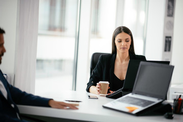 Young businesswoman working on lap top. Beautiful woman in office.	