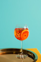Spritz Aperol veneziano, an IBA cocktail with Prosecco or white sparkling wine, bitter, soda, ice and a slice of orange, in a calix on a table, pop graphic style