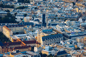 Classic Parisian buildings. Aerial view of roofs. Paris roofs panoramic overview at summer day, France. View of typical parisian roofs with mansards and chimneys in Paris, France.