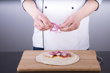 Obraz na płótnie Canvas Chef cooking shawarma in restaurant kitchen