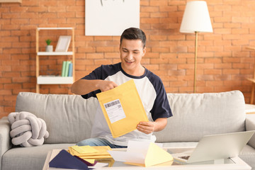 Young man with letters at home