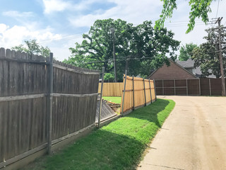 Fototapeta na wymiar Large backyard of corner house with wooden fence replacement in progress suburbs Dallas, Texas, USA