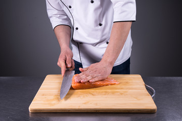 chef cuts salmon for fresh sushi in a restaurant kitchen2