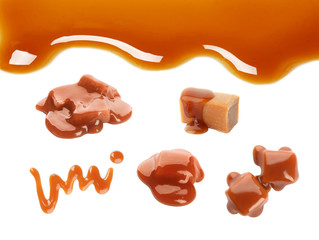 Set with caramel candies and tasty sauce on white background