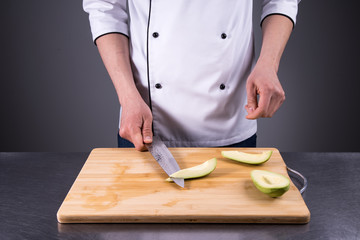 chef cuts and cleans a ripe avocado in the restaurant kitchen7