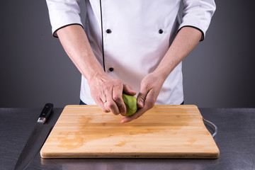 chef cuts and cleans a ripe avocado in the restaurant kitchen2