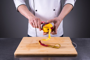 chef slices and peels ripe mango in the restaurant kitchen5