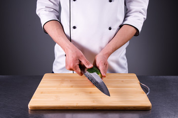 chef cuts cucumber in the restaurant kitchen5