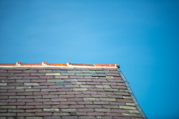 Slate rooftop in a blue sky