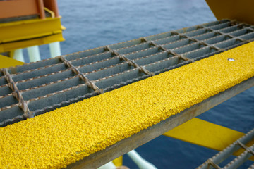 Close up of industry steel staircase with yellow anti slip plate on the tread.