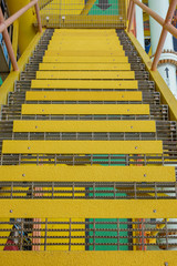 Industry steel staircase with yellow anti slip plate on the tread.