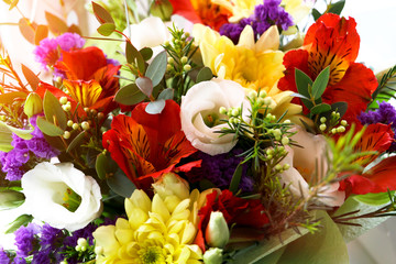 Multicolored bouquet of flowers.Close up photography,different green stuff.