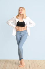Slim woman on color background