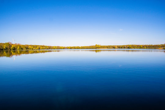 Beautiful, blue and deserted Unisee - a lake in Bremen at sun and blue sky
