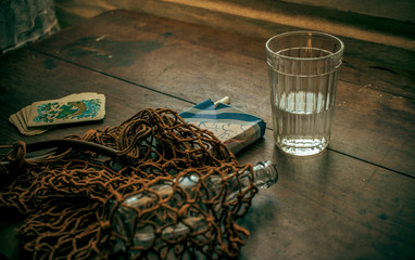 A string bag with a bottle, cigarettes and maps.Still life of the past Soviet Union