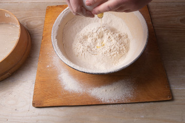 Female hands mixing dough in the home kitchen.