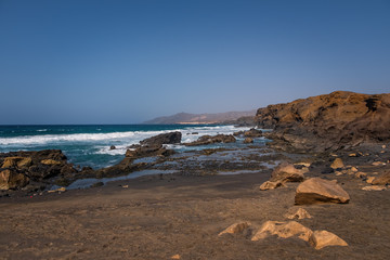 Fototapeta na wymiar La Pared volcanic beach or Playa de La Pared on Fuerteventura south west coast, Canary Islands, Spain, with eroded landscape and black sand. October 2019