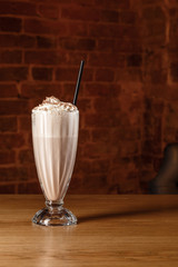Milkshake horchata in a fine presentable glassware bricks background photography. Beverage picture...