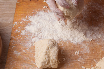 Female hands mixing dough in the home kitchen.