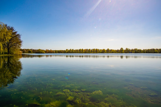 Beautiful, blue and deserted Unisee - a lake in Bremen at sun and blue sky